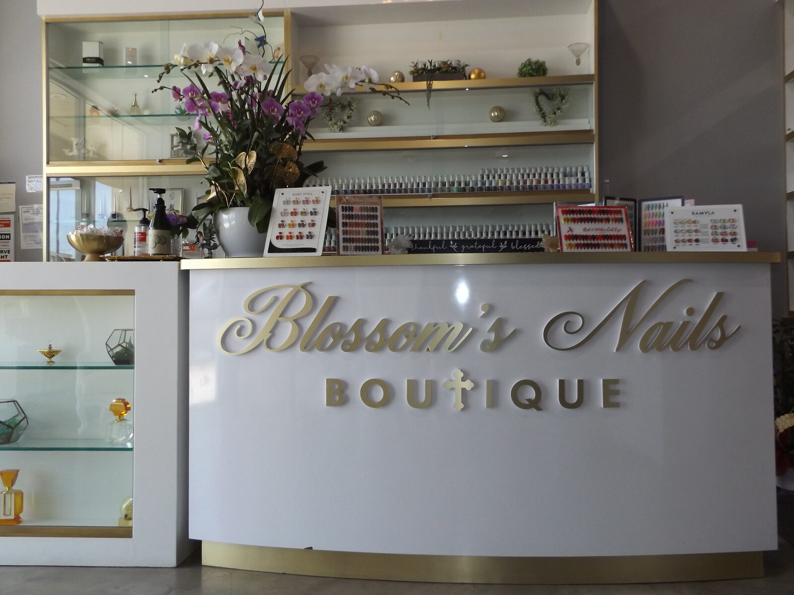 Blossom's Nails Boutique gold reception desk and signage