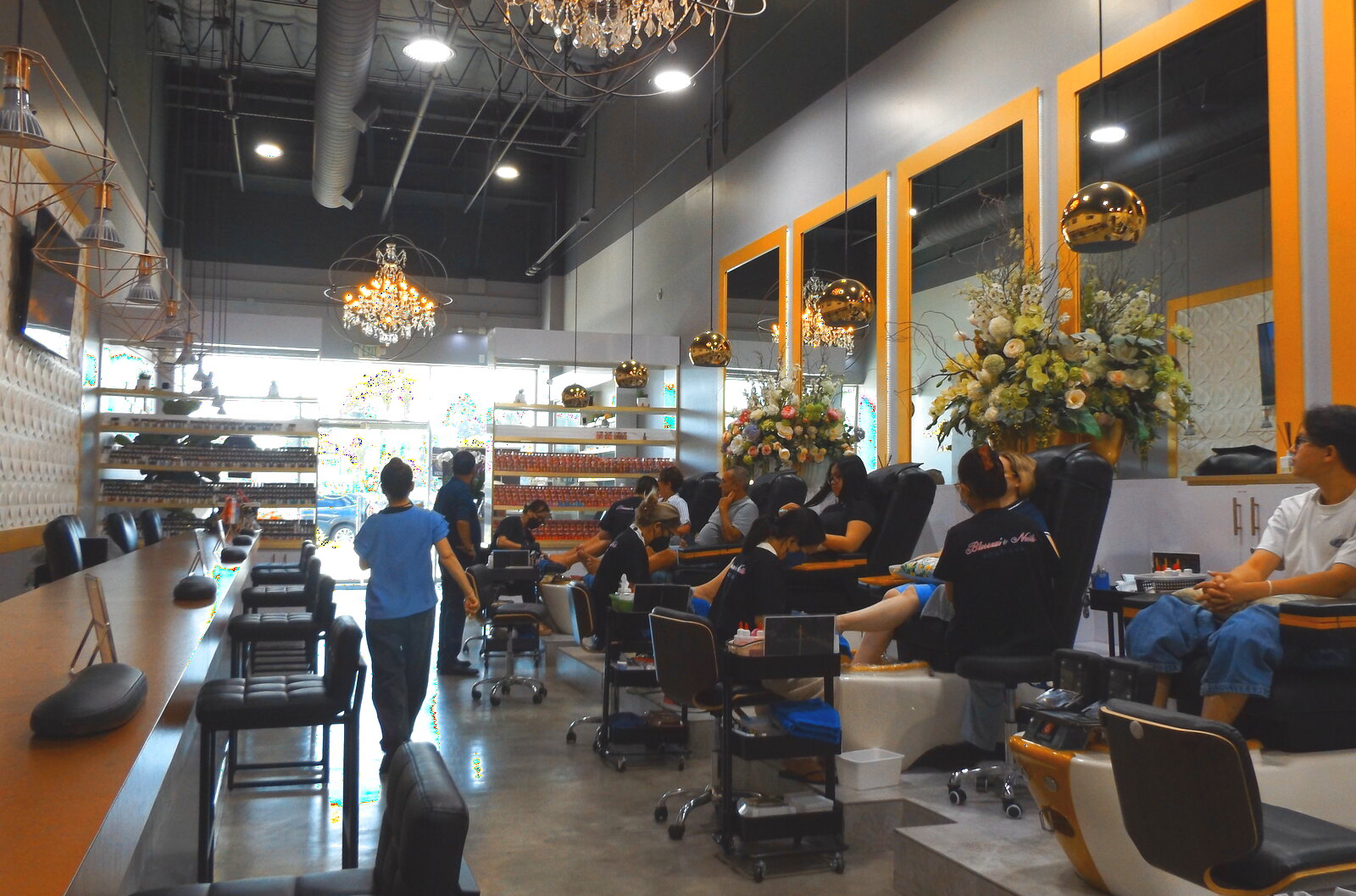 The Blossom's Nails Boutique salon floor with chandeliers and pedicure stations